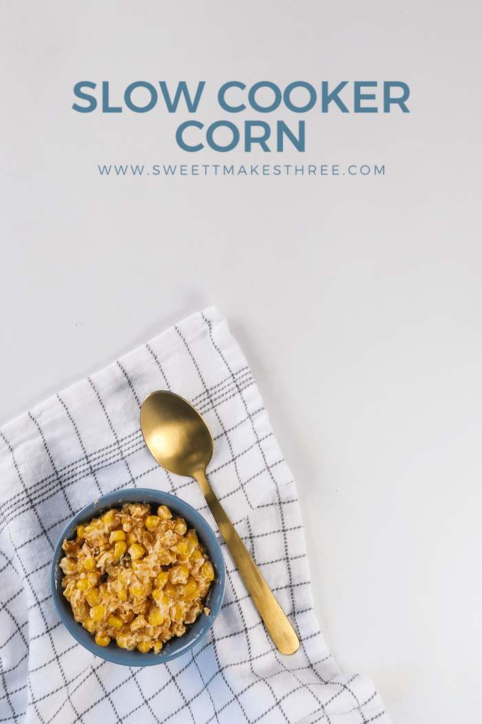 crock pot creamed corn recipe served in a bowl with a napkin and spoon