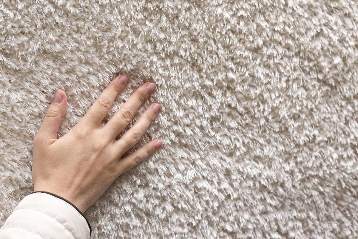 A hand feeling plush, beige carpet.