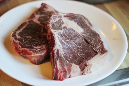 raw chuck eye steaks on a plate