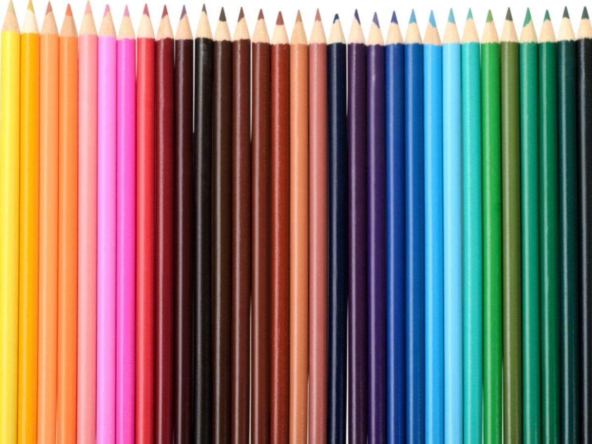 A row of sharpened colored pencils organized by color.