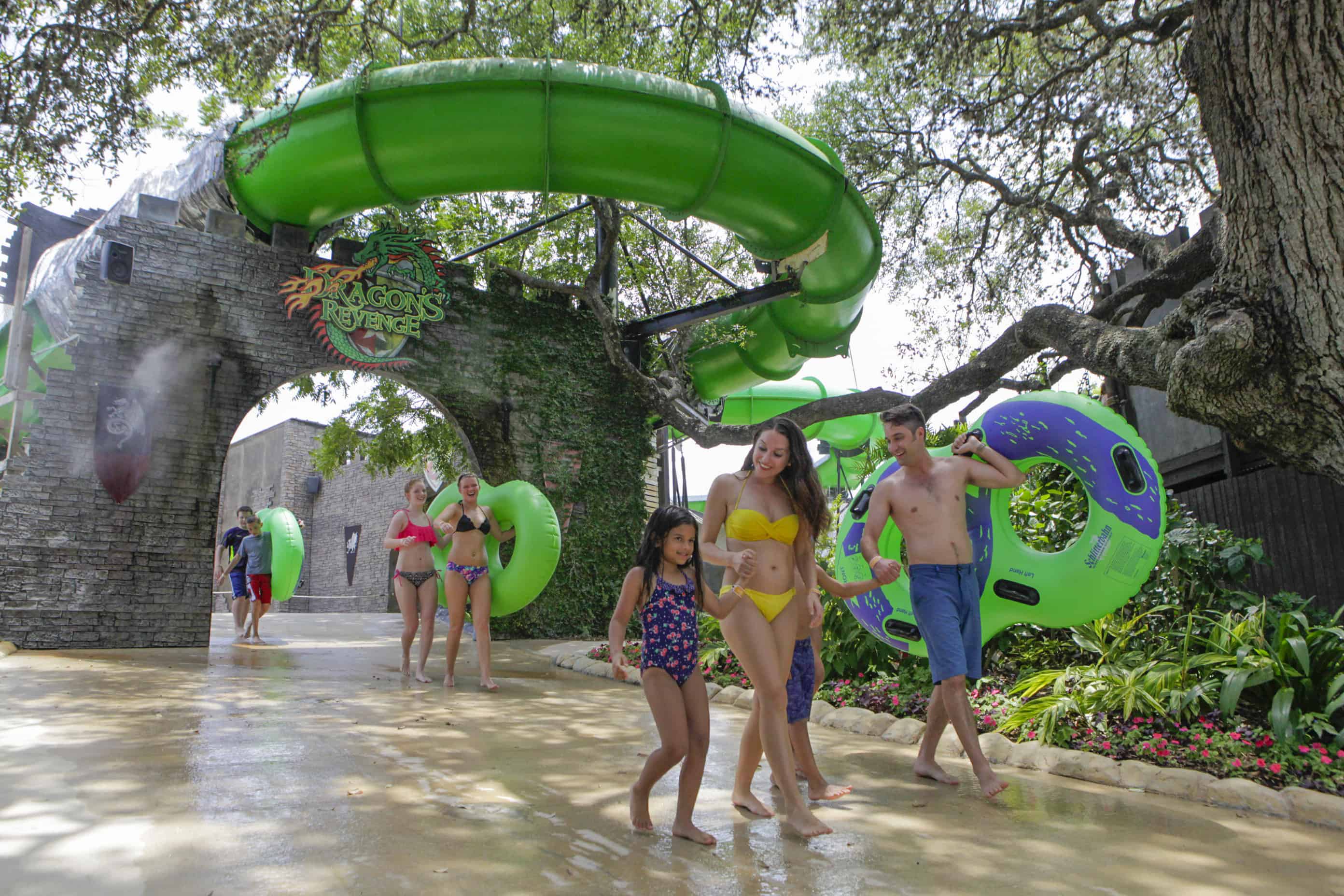 family walking in front of a green waterslide