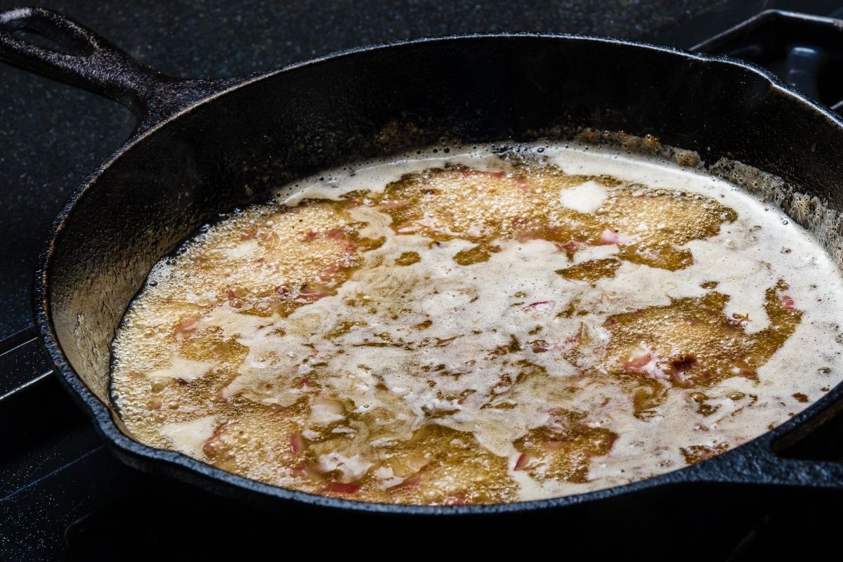Hot bacon drippings in an iron skillet.