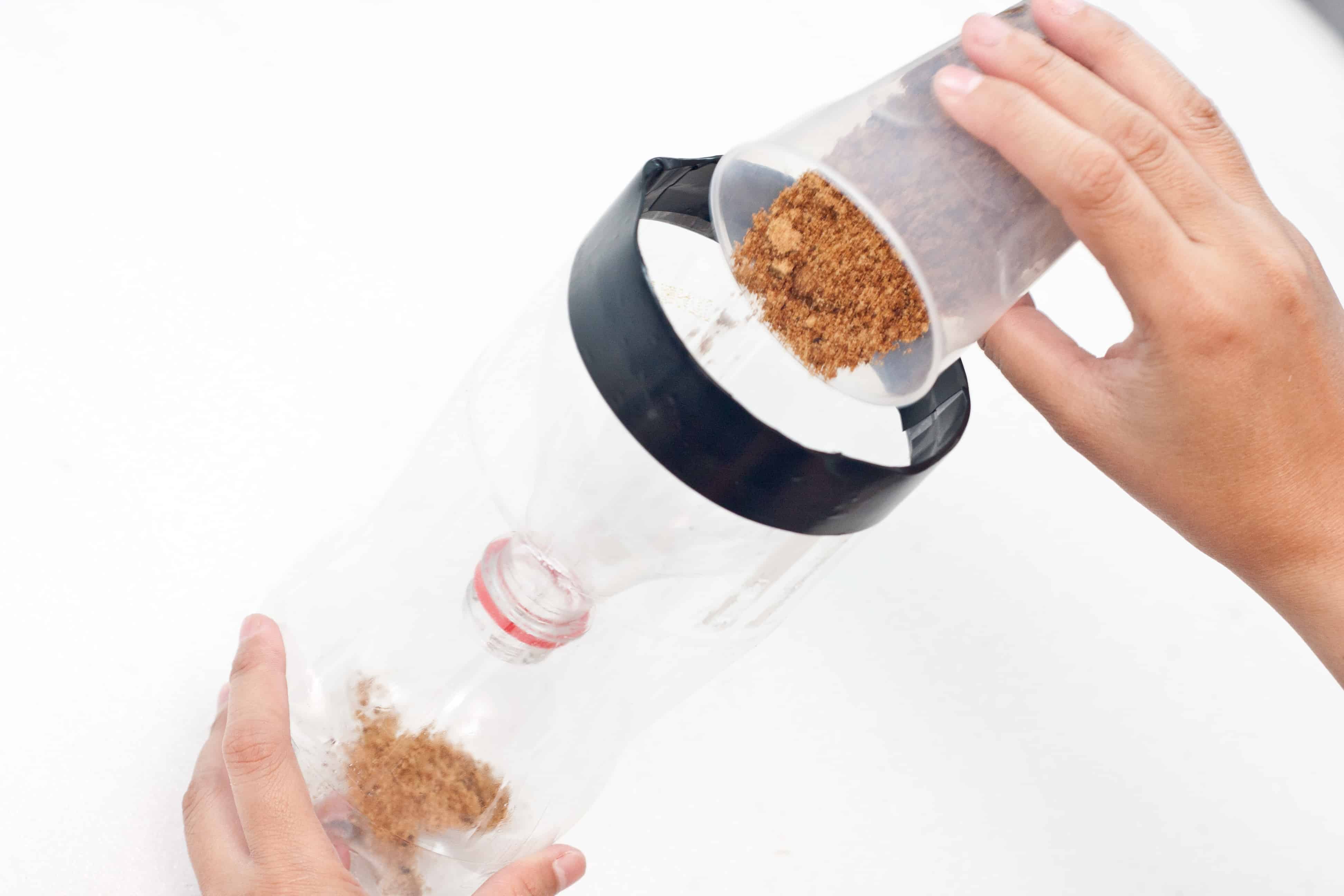pouring brown sugar into a homemade fly trap