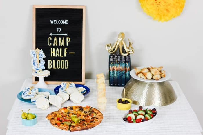 party table with greek food and ocean themed cookies