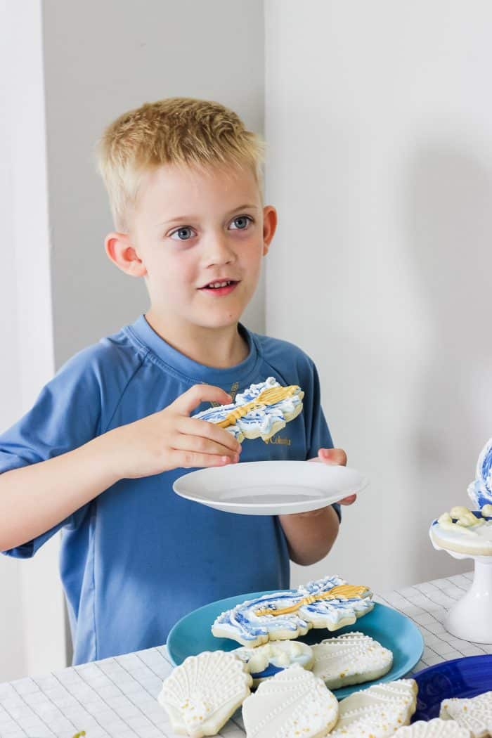 child eating a trident cookie at a percy jackson birthday party