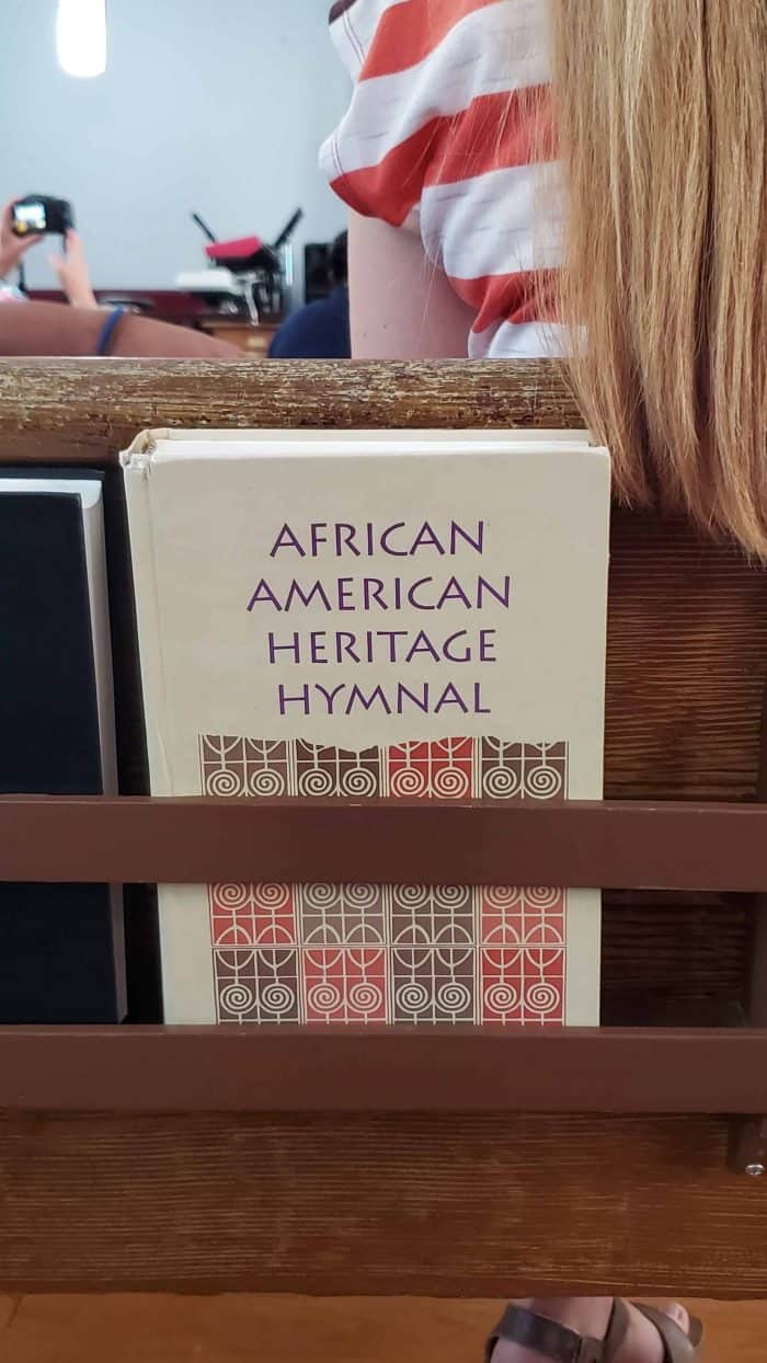 african american heritage hymnal resting in a pew back 