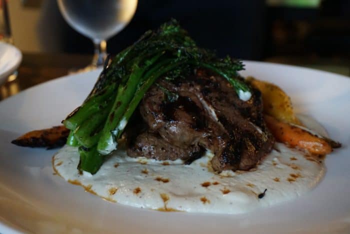 lamb on a bed of creme fraiche topped with broccolini