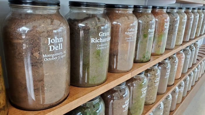 jars of dirt labeled with the name of the people lynched on the site where the dirt was collected