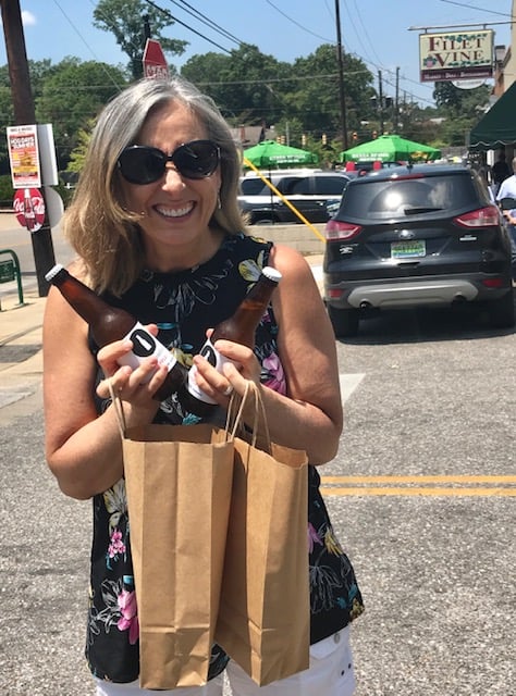 woman holding local Alabama kumbucha bottles