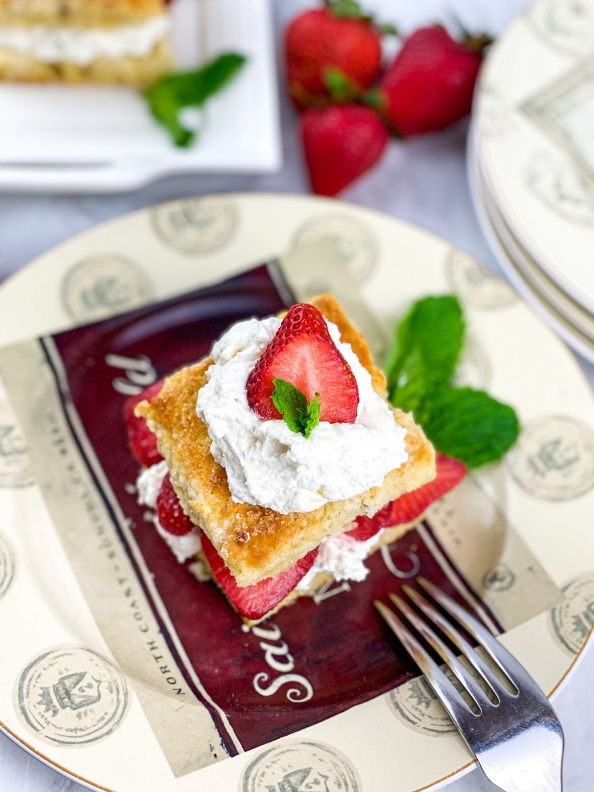 Top view of complete strawberry shortcake recipe served on a plate with a silver fork.