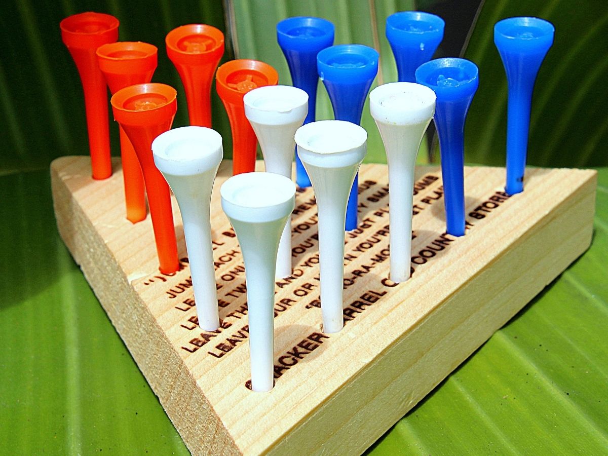 close up shot of the cracker barrel triangle peg game with a wooden base and red, white, and blue pegs.