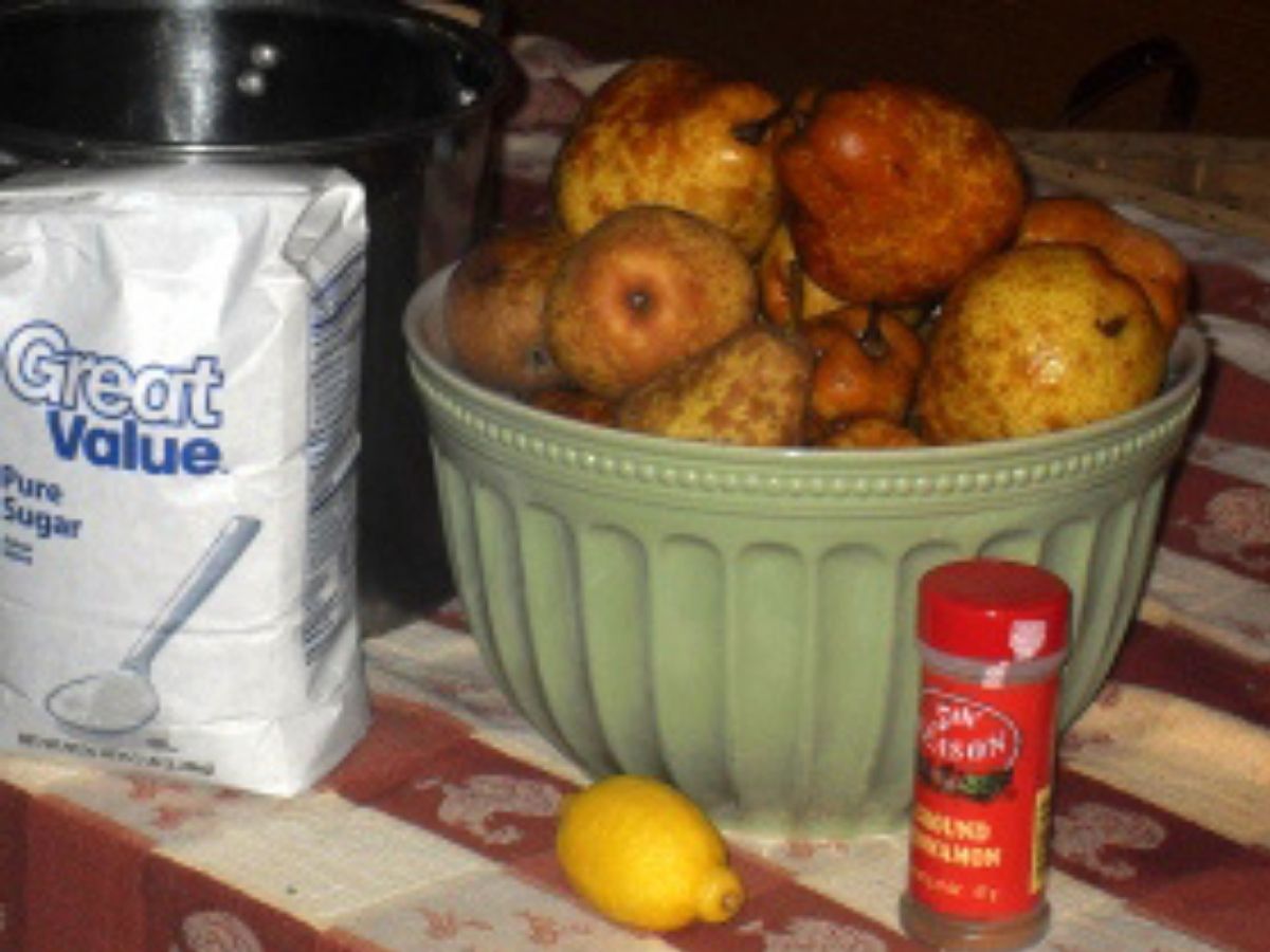 a bowl of freshly picked pears, flour, cinnamon, and a lemon