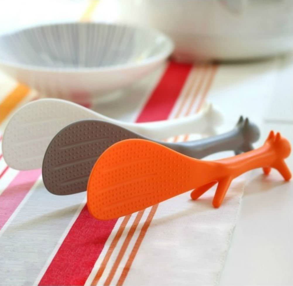 Three squirrel shaped rice paddles in orange, gray, and white.