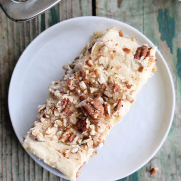 Banana bar slice topped with toasted pecans.