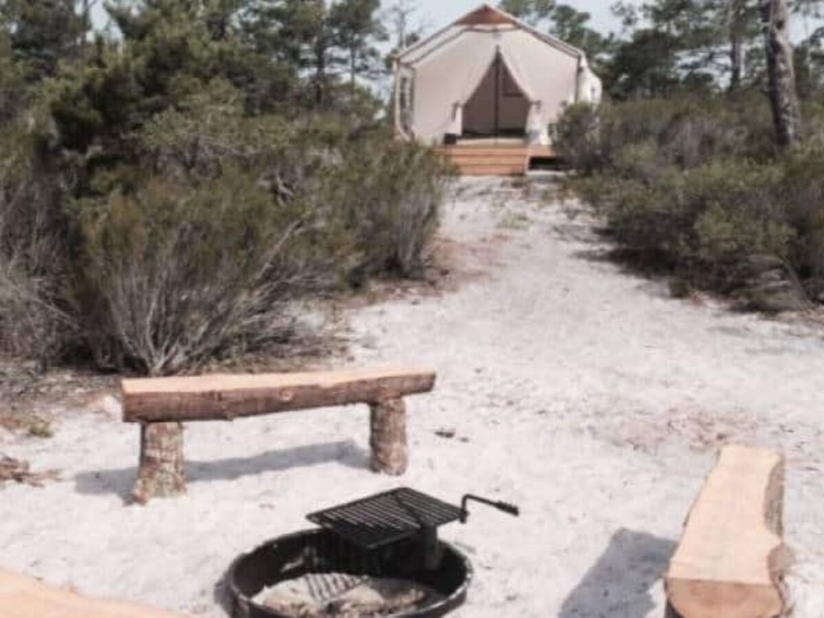 Fire pit outside a glamping tent campsite in Gulf State Park.