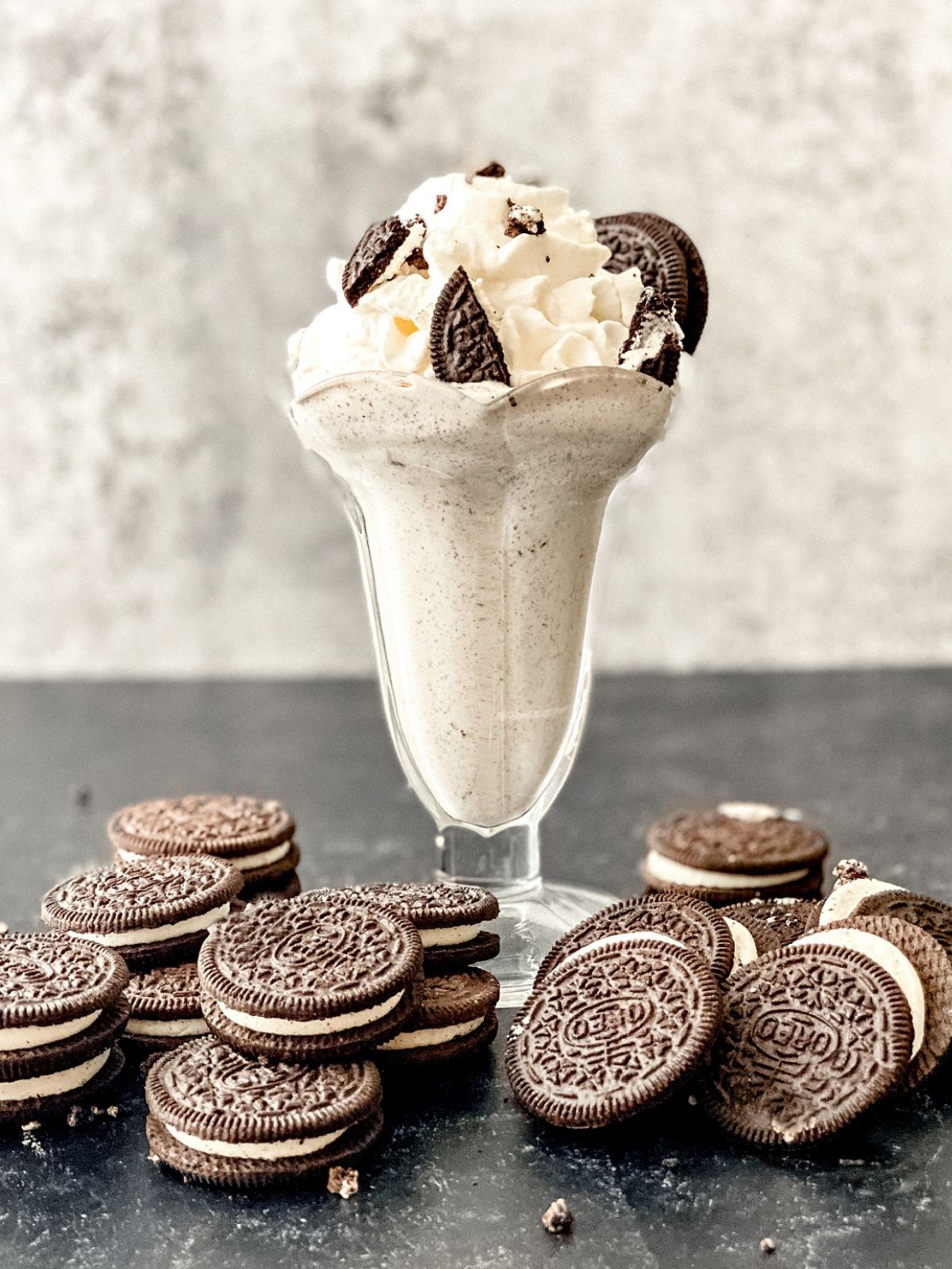 A homemade Oreo McFlurry in a parfait glass topped with whole oreo cookies as a garnish.