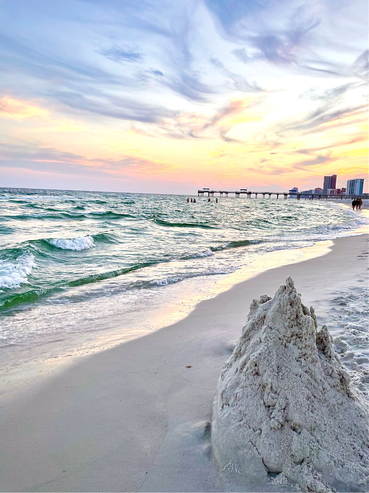 Sandcastle slowly crumbling along the Gulf Coast at sunset on Orange Beach in Alabama.