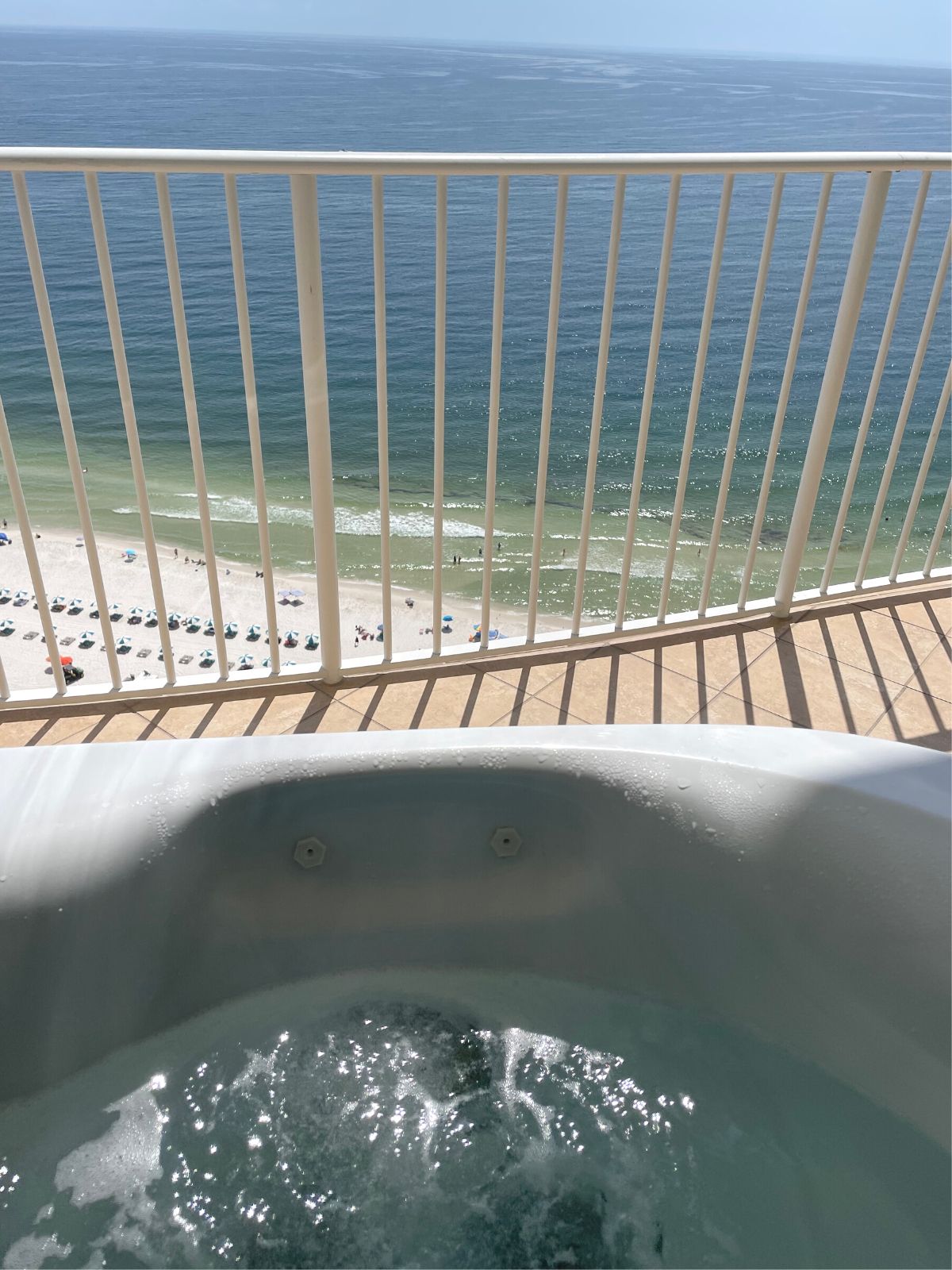 View from the private balcony hot tub looking down at the sand and surf.