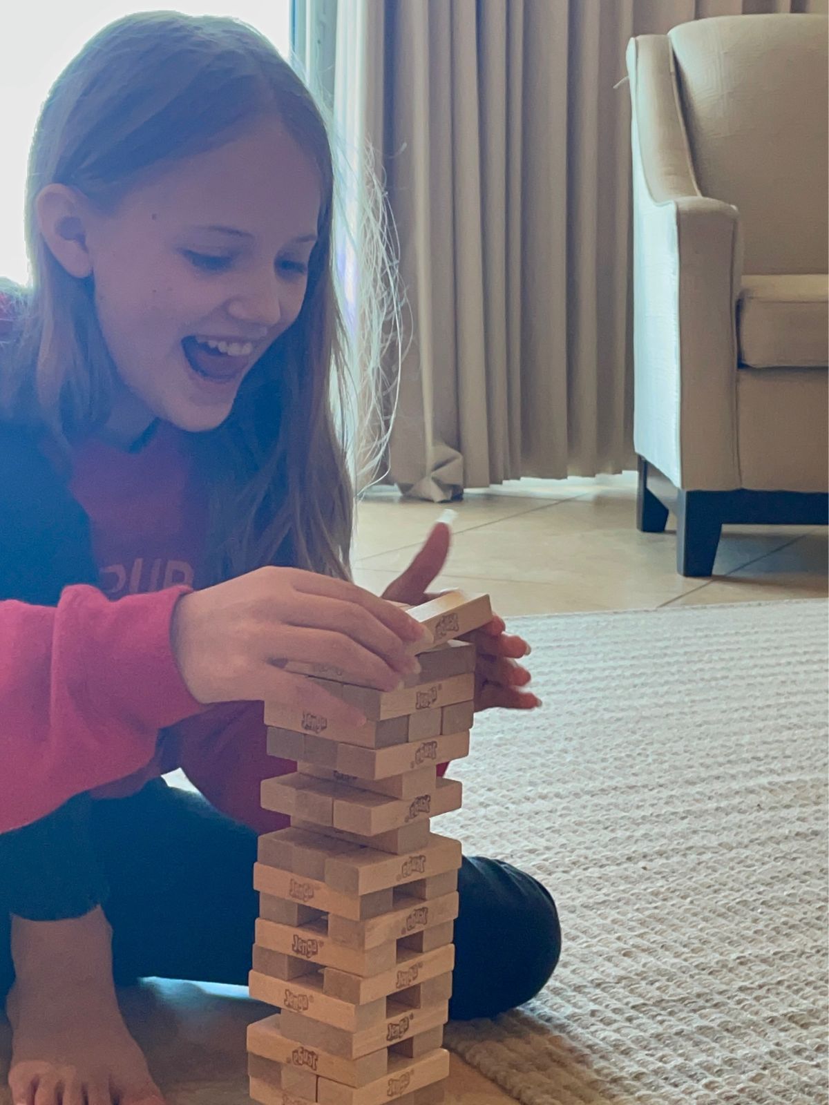 Playing Jenga on the floor of a Turquoise Place beach rental.