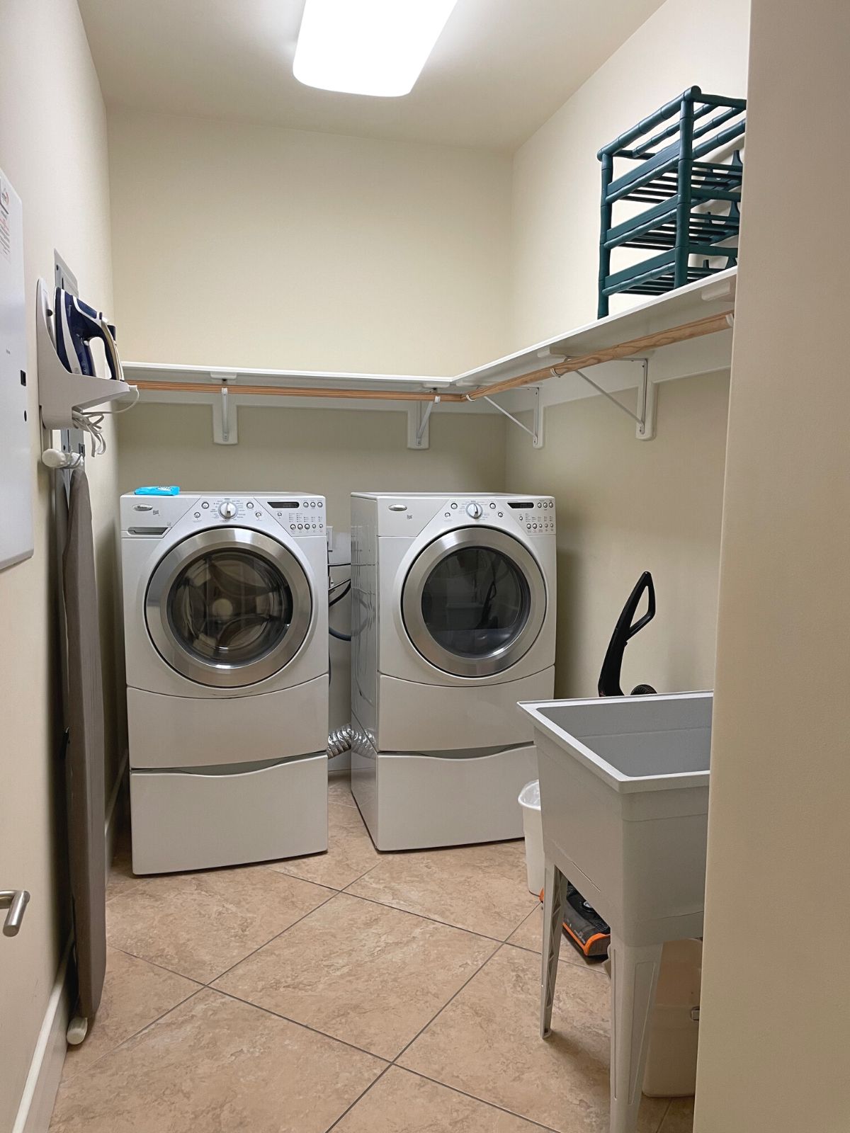 Laundry room in the units at Turquoise place with washer, dryer, and sink.