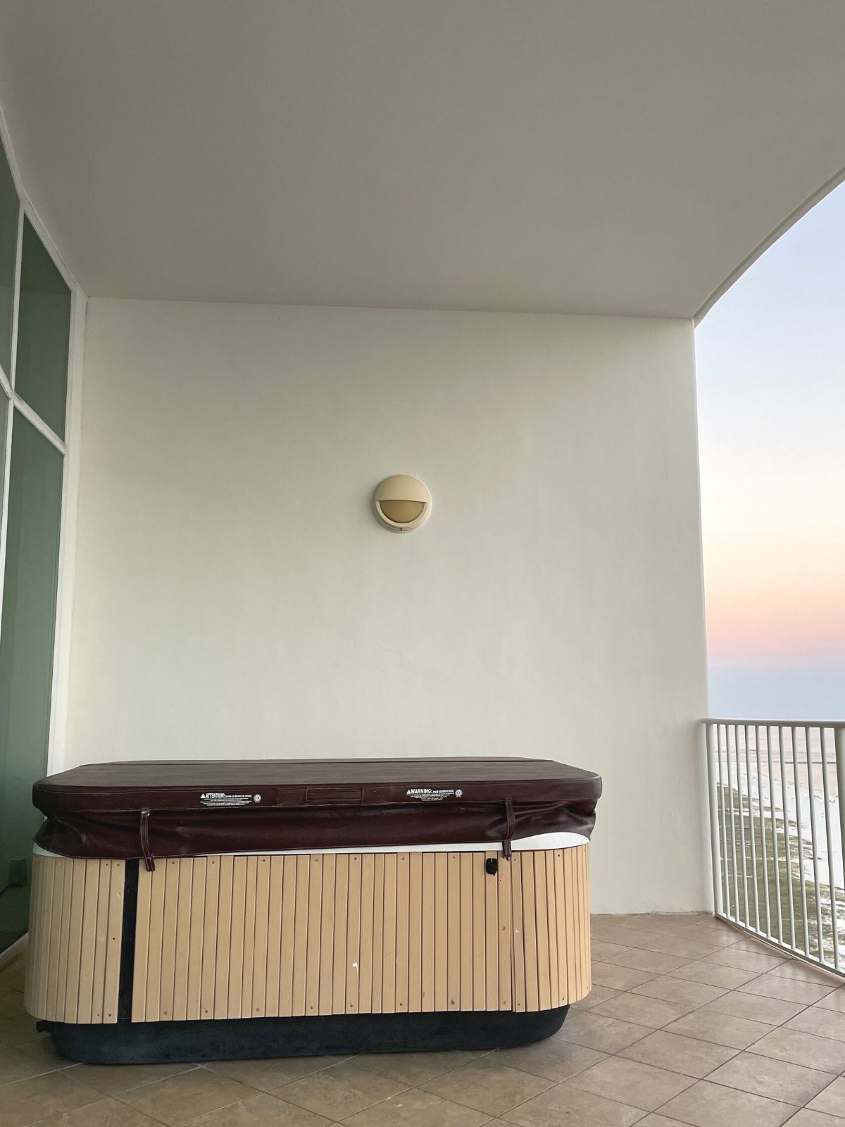 Balcony hot tub with a cover in place.