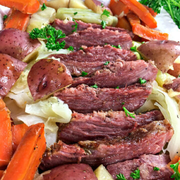 Platter of corned beef and cabbage with potatoes and carrots.