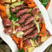 Platter of corned beef and cabbage with potatoes and carrots.