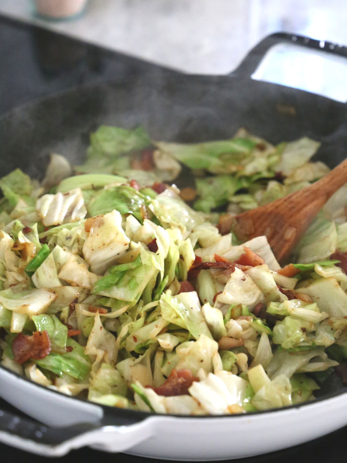 Cabbage frying in a pan.