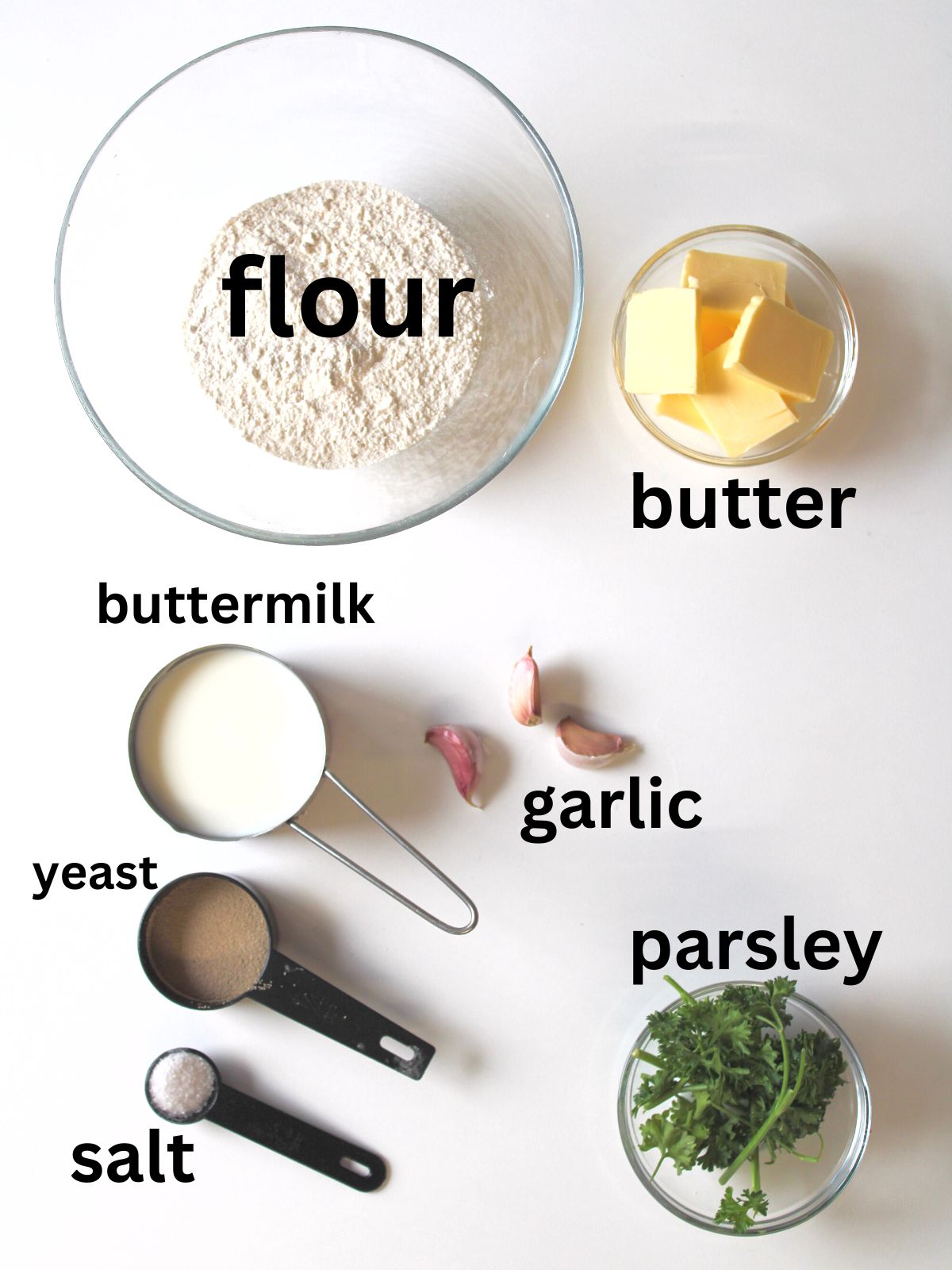 Garlic bread ingredients including flour, butter, buttermilk, garlic, parsley, yeast, and salt.