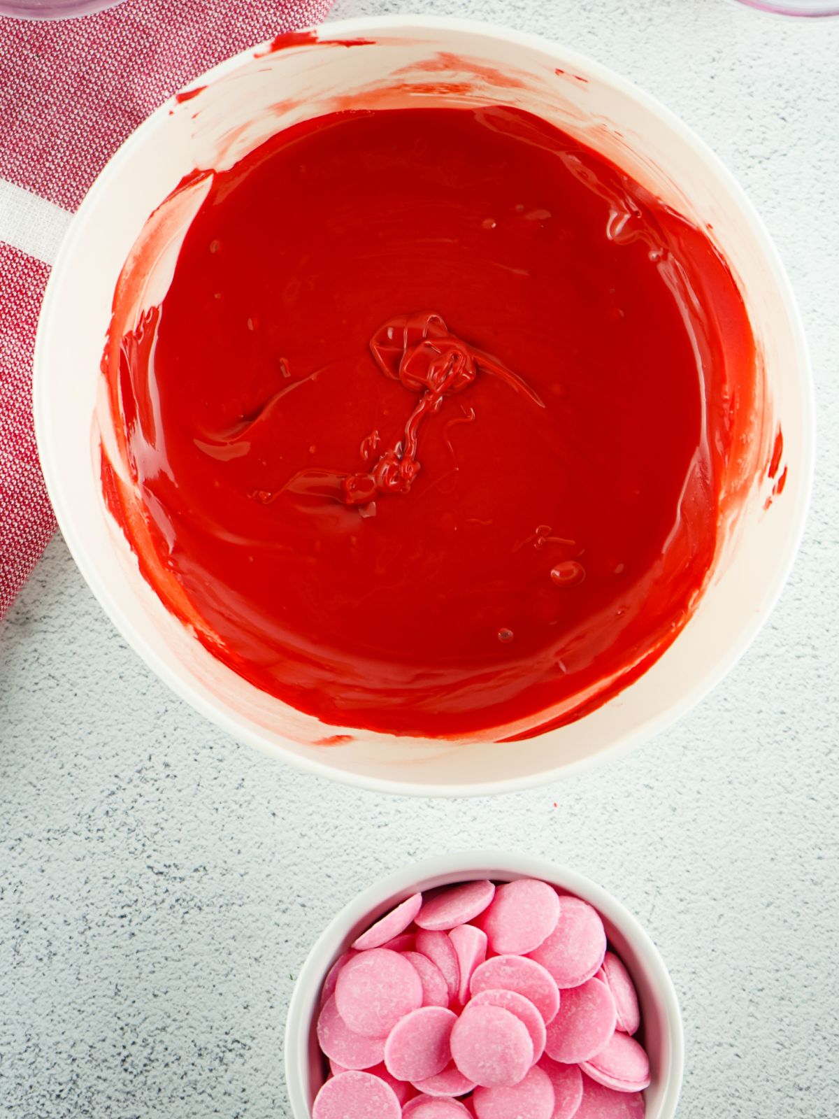 Red melted candy melts in a glass bowl.
