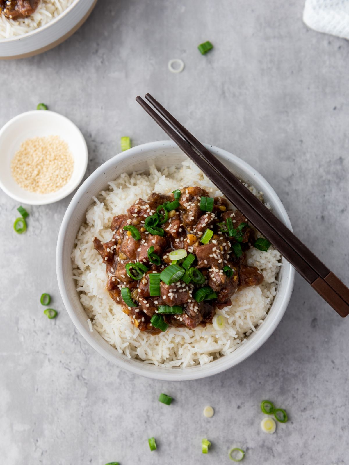 A bowl of slow cooker Mongolian beef served over rice.